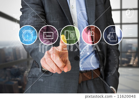 Composite image of businessman in grey suit pointing at menu 11620048