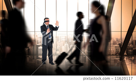 Composite image of mature businessman in a blindfold Composite image of mature businessman in a blindfold 11620117