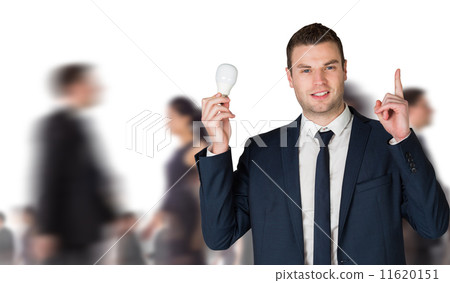 Composite image of businessman holding light bulb and pointing Composite image of businessman holding light bulb and pointing 11620151