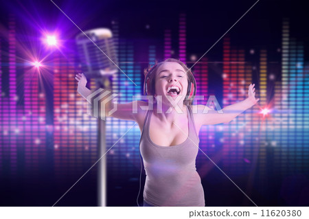 Composite image of pretty girl listening to music 11620380