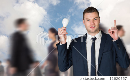 Composite image of businessman holding light bulb and pointing Composite image of businessman holding light bulb and pointing 11620567