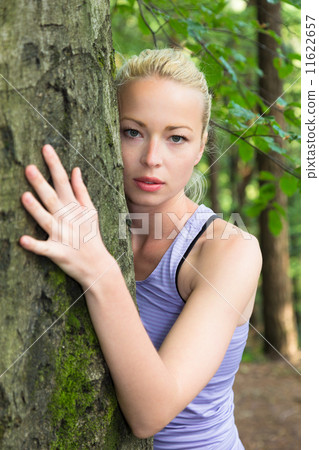 Young woman hugging a tree. Young woman hugging a tree. 11622657