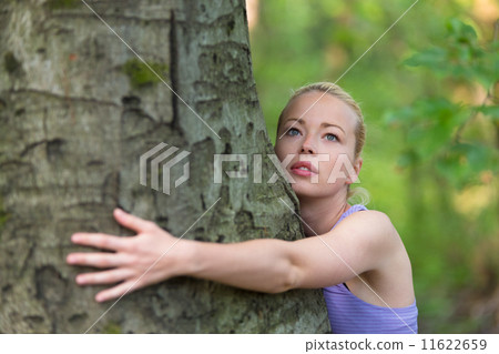 Young woman hugging a tree. Young woman hugging a tree. 11622659