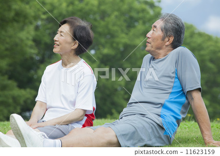 A couple sitting on the lawn A couple sitting on the lawn 11623159