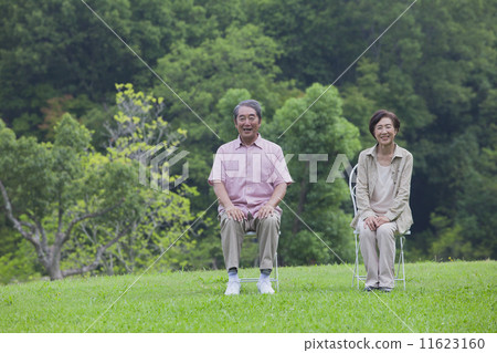 A couple sitting in a chair A couple sitting in a chair 11623160