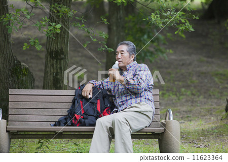 Senior men taking a break on the bench Senior men taking a break on the bench 11623364