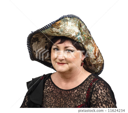 Mature woman in tapestry hat looking at camera 11624234