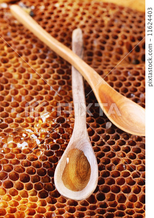 Wooden spoon on honeycombs 11624403