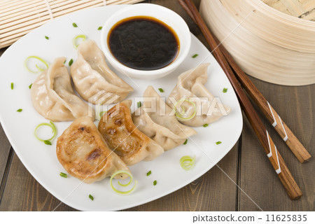 Yaki-Gyoza - Japanese pan-fried dumplings with dipping sauce  11625835