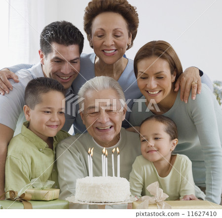 Senior Hispanic man celebrating birthday with family 11627410