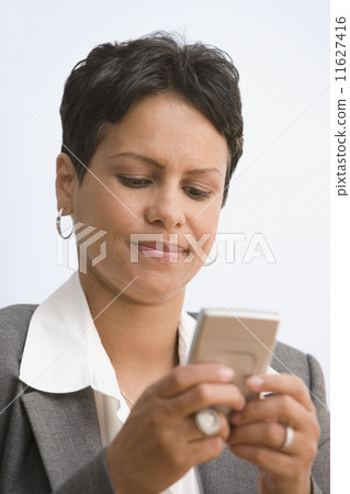 African businesswoman dialing cell phone 11627416