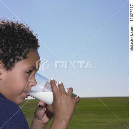 Young boy drinking a glass of milk 11627417