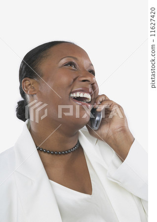 Studio shot of African woman on her cell phone  11627420