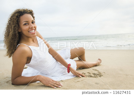 African woman laying on sand 11627431