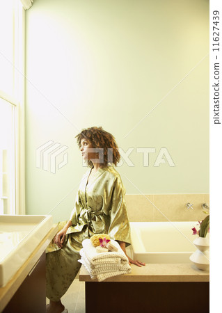 African American woman sitting on bathtub 11627439
