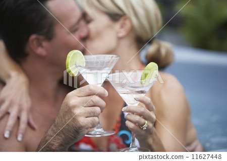 Couple kissing in hot tub 11627448