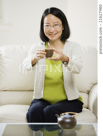 Asian woman drinking tea Asian woman drinking tea 11627460