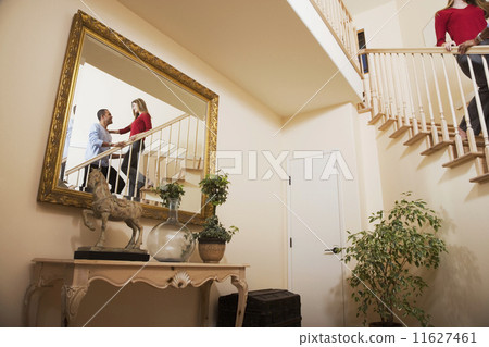 Reflection of Multi-ethnic couple on stairs Reflection of Multi-ethnic couple on stairs 11627461