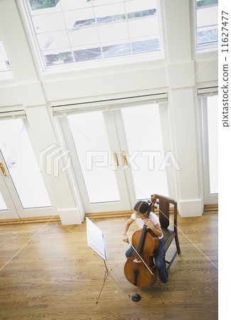 High angle view of Asian girl playing cello 11627477