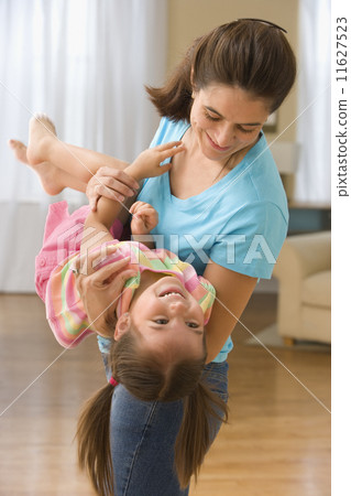 Mother swinging daughter in arms Mother swinging daughter in arms 11627523