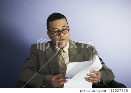 African American businessman reading paperwork 11627556