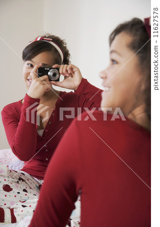 African twin sisters taking photograph African twin sisters taking photograph 11627578