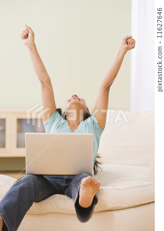 Indian woman with laptop cheering Indian woman with laptop cheering 11627646