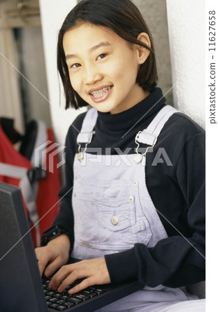 Asian girl typing on laptop 11627658
