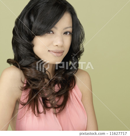 Studio shot of Asian woman smiling Studio shot of Asian woman smiling 11627717