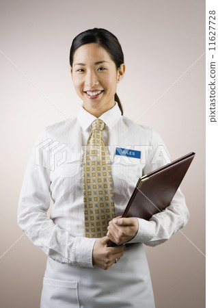 Asian woman wearing name tag and holding folder 11627728