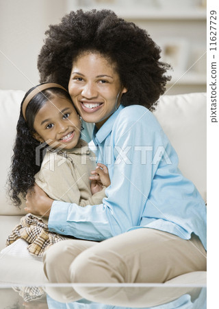 African mother and daughter hugging 11627729
