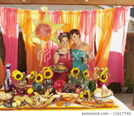 Mother and daughter behind buffet table 11627740