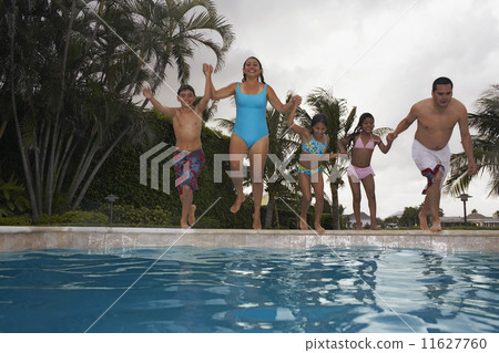 Multi-ethnic family jumping into swimming pool Multi-ethnic family jumping into swimming pool 11627760