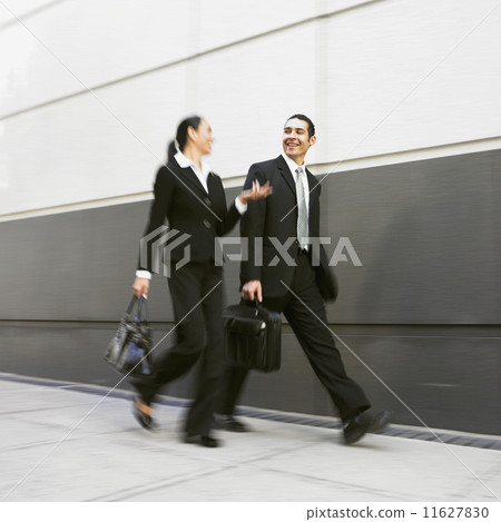 Hispanic businesspeople walking Hispanic businesspeople walking 11627830