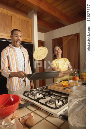 Man flipping pancake 11627837