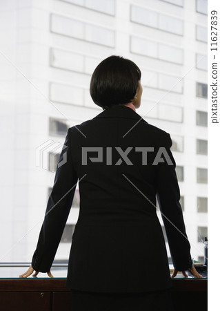 Businesswoman gazing out window 11627839