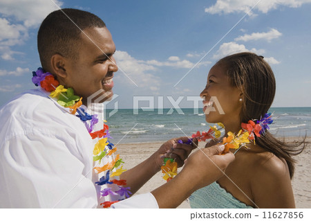 African couple wearing leis 11627856