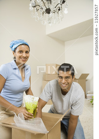 Indian couple unpacking moving boxes 11627857