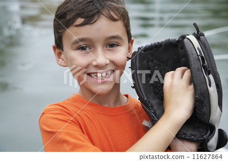 Boy wearing baseball mitt 11627864