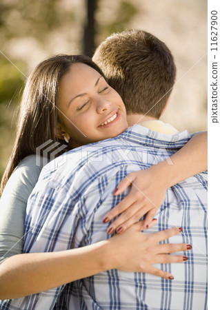 Hispanic woman hugging boyfriend 11627900