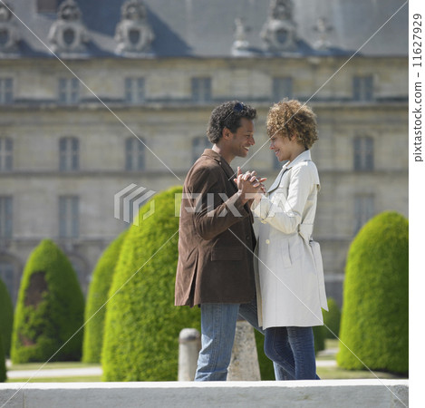 African couple smiling at each other in front of historical building African couple smiling at each other in front of historical building 11627929