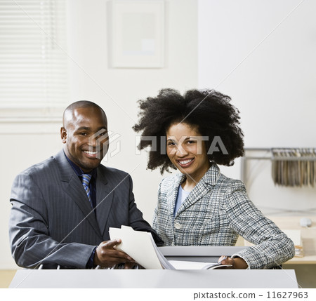 African American businesspeople holding folder African American businesspeople holding folder 11627963