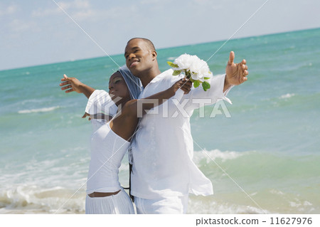 African bride and groom at beach 11627976
