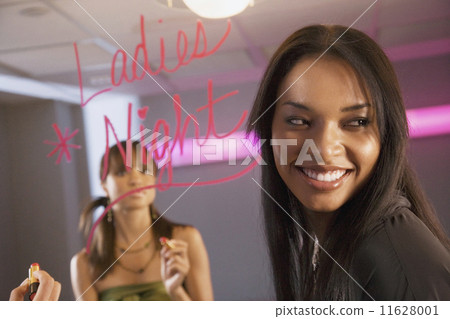 African women writing on bathroom mirror 11628001