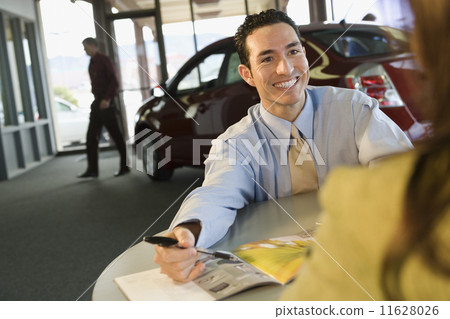 Car salesman smiling at customer Car salesman smiling at customer 11628026