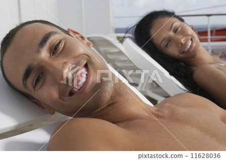 Hispanic couple sunbathing 11628036