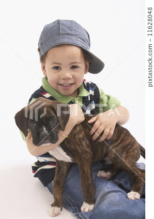 Young African boy holding puppy 11628048