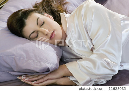 Woman sleeping in silk pajamas 11628083