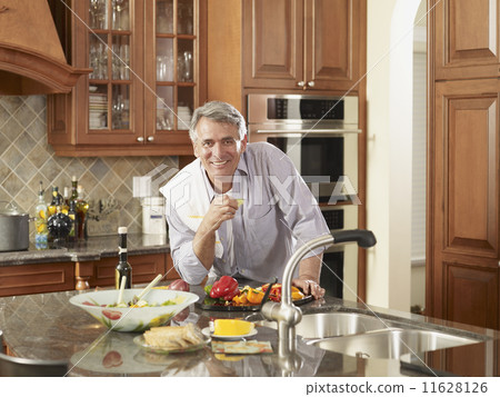 Hispanic man preparing food Hispanic man preparing food 11628126