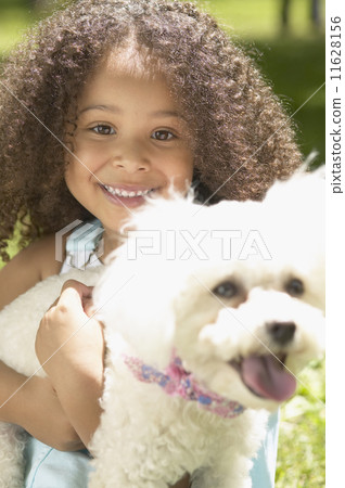 Close up of African girl holding dog Close up of African girl holding dog 11628156